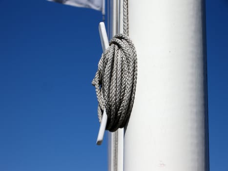 Closeup flagpoles in a rowe.