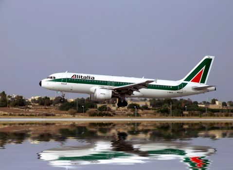Italian Alitalia jet landing on an airport runway