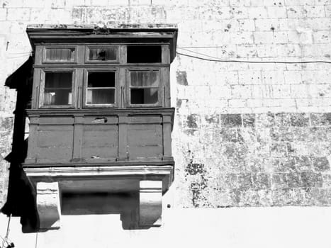 Medieval battered and derelict balcony of house in the old city of Mdina, Malta