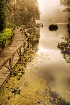 Dramatic sunrise scenery with peace lake and beautiful forest.