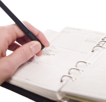 Man writing in a personal organizer, short focal lenght