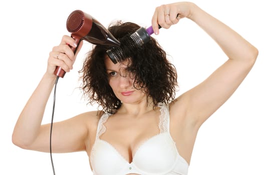 The woman dries the hair dryer hair