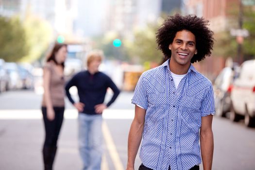 A happy young adult in a city setting with friends