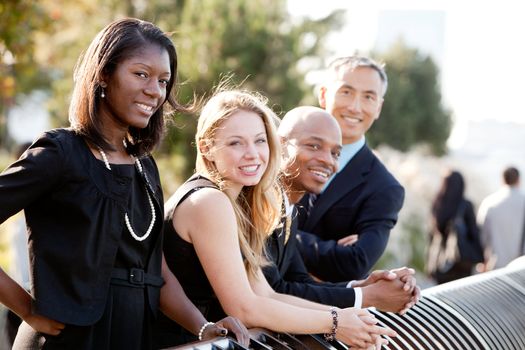 A business team outside - sharp focus on front woman