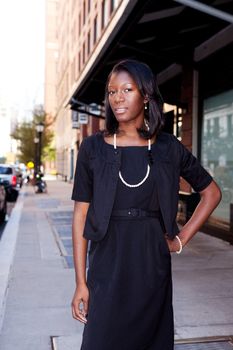 An African American business woman in an urban setting.