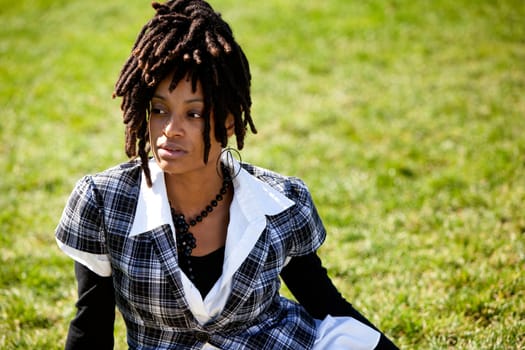 A beautiful African American woman isolated on grass