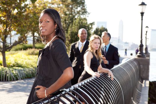 A business team outside - sharp focus on front woman