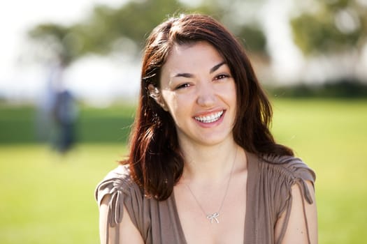 A young woman with friendly smile looking at the camera