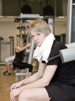 Man taking a break from the exercise at a fitness center