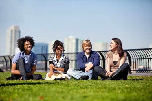 A group of friends in a city park talking and laughing