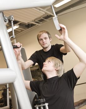 Man instructing how to use an exercise machine
