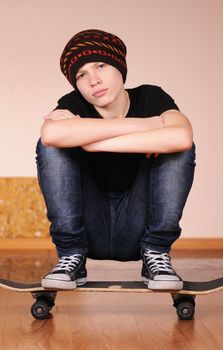 The teenager with a skateboard and in a hat