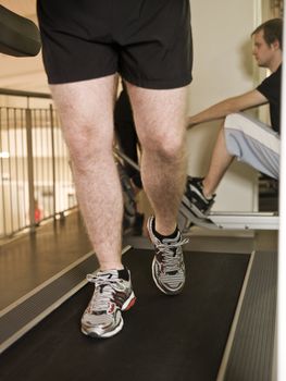 Man running on a treadmill in a healthclub