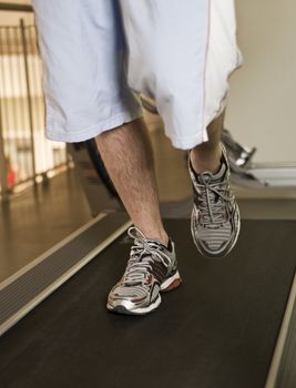 Man running on a treadmill in a healthclub