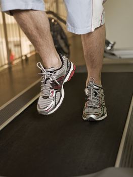 Man running on a treadmill in a healthclub