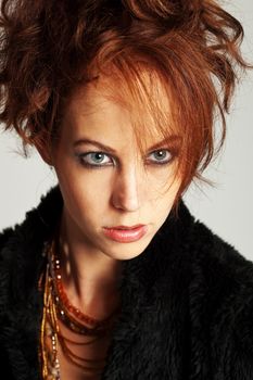 Beautiful woman with wild hairstyle looking intense