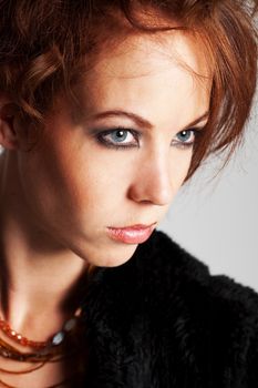 Beautiful woman with red hair and intense look