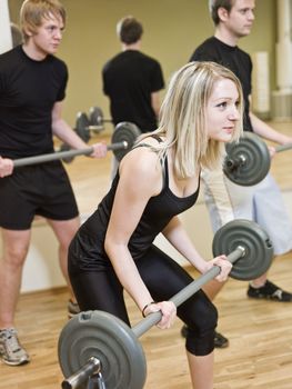 Girl lifting weights at the gym