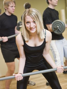 Girl lifting weights at the gym