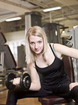 Young woman lifting weights at a fitness center