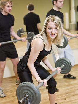 Girl lifting weights at the gym