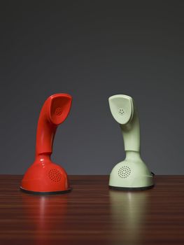 Two cobra phones on a desk with a grey background