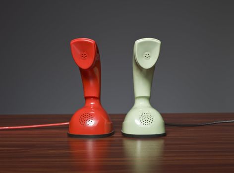 Two cobra phones on a desk with a grey background