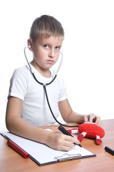 7 years old boy as a doctor isolated on white 