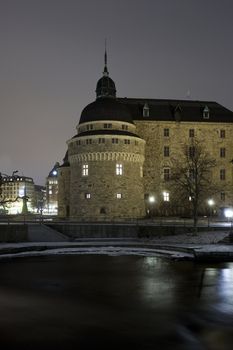 Castle at night time with ice on the water