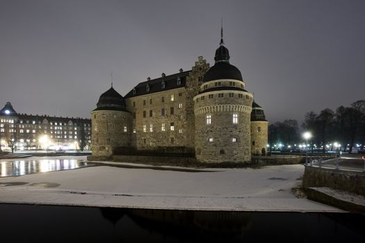 Castle at night time with ice on the water