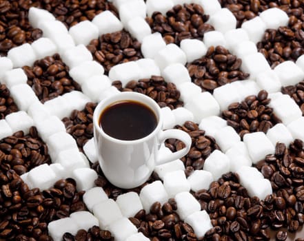 cup of coffee with coffee beans and sugar