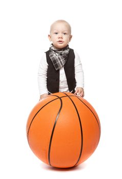 Fashion boy playing whit a huge basketball against a white background