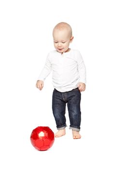 Boy playing with a red ball isolated against a white background