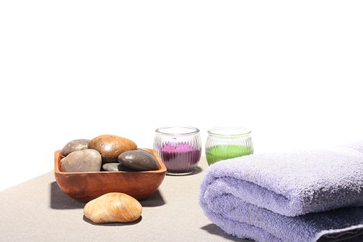 Terry towel, sea stones in a basket and two aromatic candles for SPA.