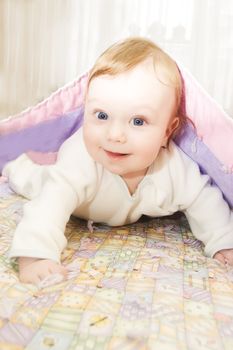 Beautiful redheaded baby boy under blanket