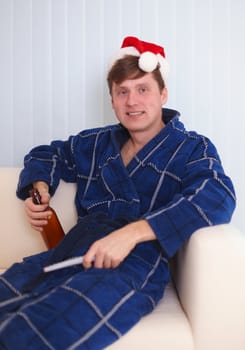 The person in red santa s cap sits on a sofa