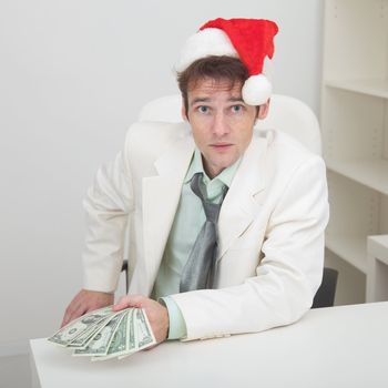 Young man with christmas hat and premium in hand