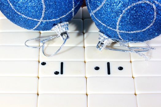 The dominoes, all counters are turned except two which create number 2011. On a back background two dark blue fur-tree spheres. A photo by new 2011.