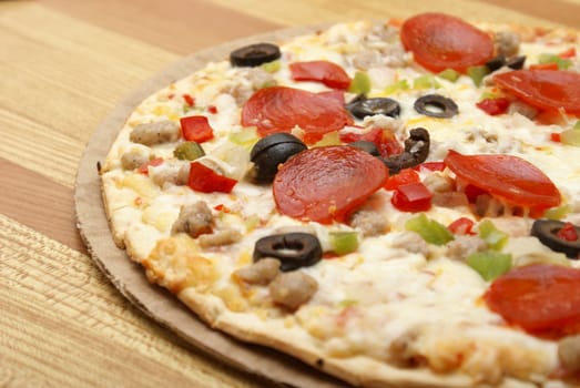 A fresh thin crust pizza sitting on the counter.