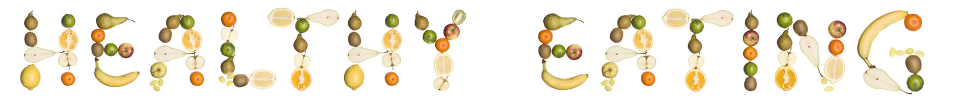 The phrase 'Healthy eating' made out of fruit isolated on a white background