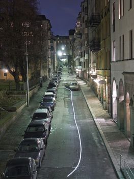 City street with cars and lights at night