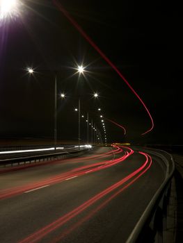 Traffic in movement at night on a bridge