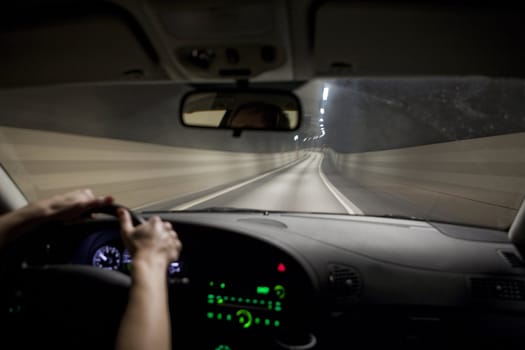 Man driving through a tunnel at night time