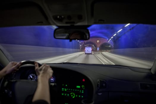 Man driving through a tunnel at night time