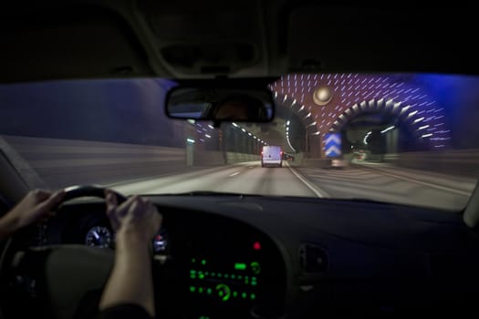 Man driving through a tunnel at night time