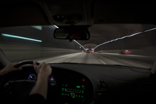 Man driving through a tunnel at night time