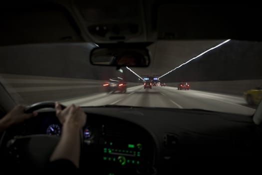 Man driving through a tunnel at night time