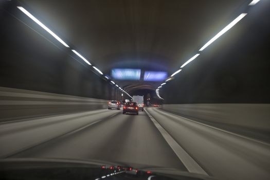 Man driving through a tunnel at night time