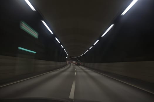 Man driving through a tunnel at night time