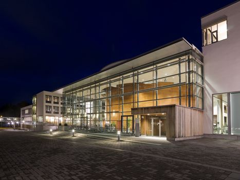 Modern glass building at night time with vivid colors